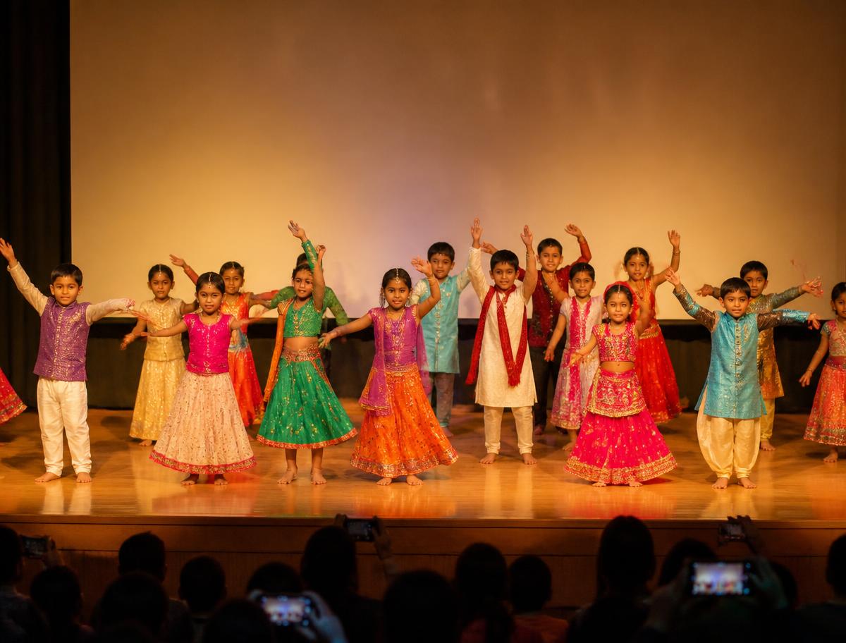 Students performing a cultural dance on the school auditorium stage